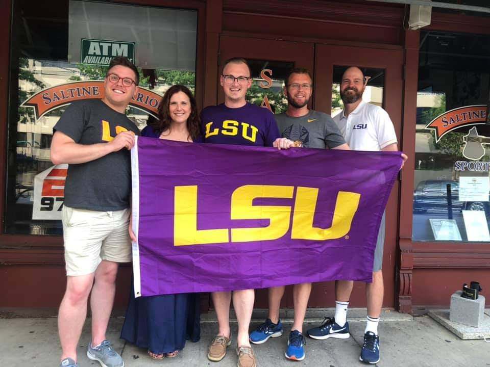 LSU Alumni behind LSU Flag